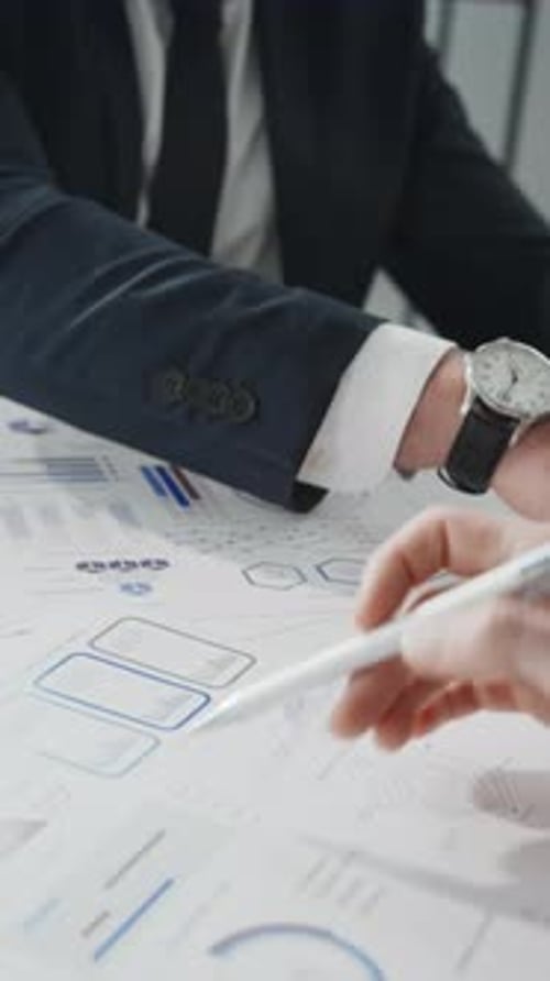 Business People Reviewing Charts and Graphs