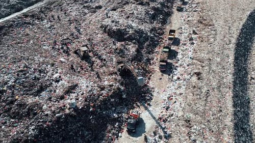 Large Waste Dump and Trash Truck with Garbage in Aerial Top View
