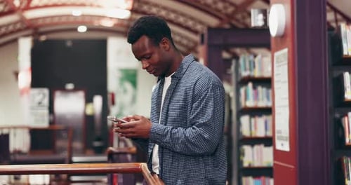 Black man, student and phone for texting in library, scroll and check announcement for exam results