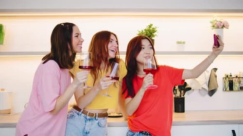 Three Close Friends are Enjoying Drinks Together While Taking Playful Selfies in a Vibrant Modern
