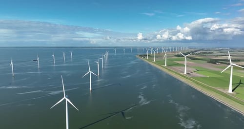 Wind farm in the sea. Clean energy production. Video background. Technology and innovation.