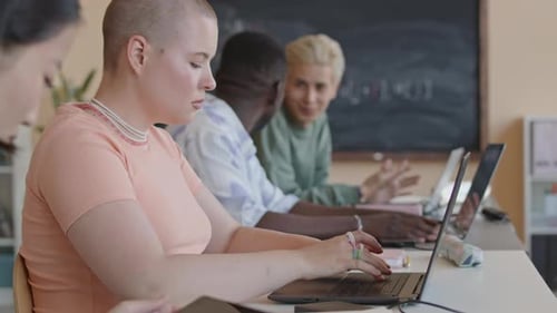 Girl Discussing Code on Laptop with Groupmate on Programming Class