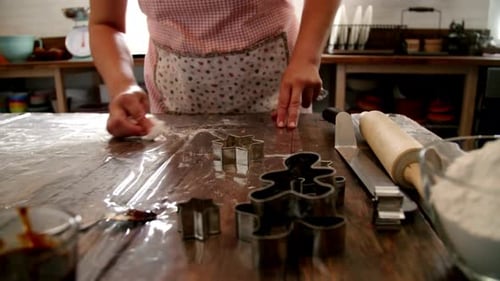 Woman Baking Christmas Cookies in Rustic Home Kitchen