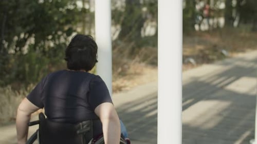 Young Woman with Disability Wheeling in Park