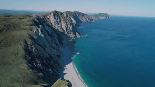 Aerial Panoramic View of the Rocky Cliffs Seaside and Waves are Crashing to the Coast Beautiful