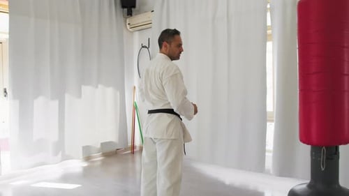 Man in Gi Practices Martial Arts Moves