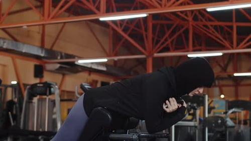 Woman Doing Back Extensions in a Gym