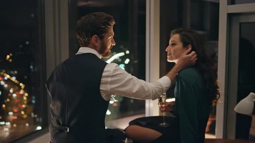 Romantic Couple Celebrating Engagement with Champagne at Night