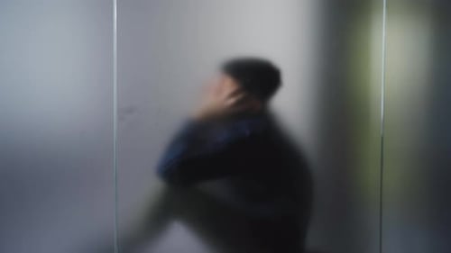 Depressed man crying secretly.