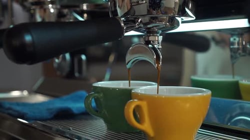 Espresso Machine Pours Coffee into Colorful Mugs
