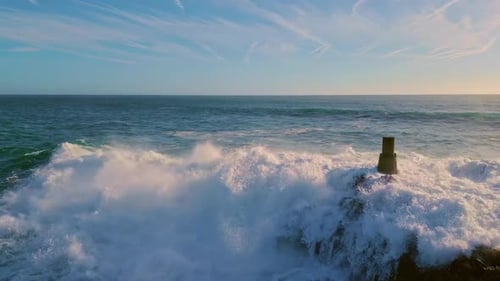Huge Waves Crashing Over Seawall in Rough Ocean Conditions