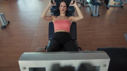 Woman Doing Leg Press Exercise in Gym