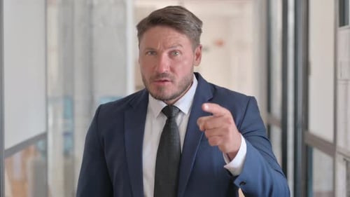 Businessman In Suit Pointing and Gesturing