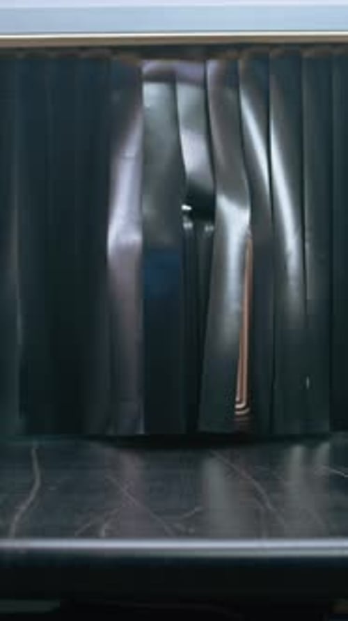 Suitcase Rolls Through Airport Security Conveyor Belt