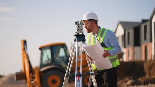 Construction Foreman Reviews Plans at Building Site