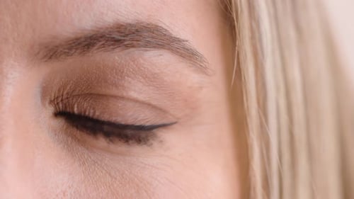 Woman, eye and optometry with blink for sight assessment, test or optic nerve reflex