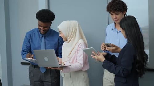 Team Collaborates on Laptop in Modern Office