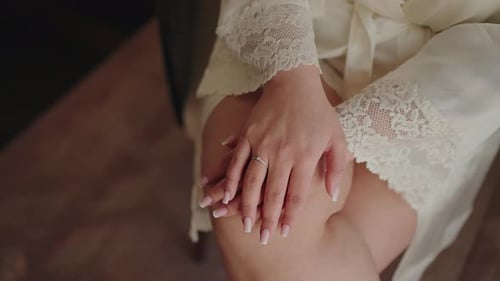 Close Up of Hands Wearing Engagement Ring