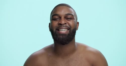 Smile, skincare and face with black man in studio for beauty cosmetics, dermatology and self care