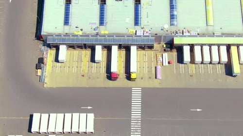 Top Down Aerial View of Semi Trucks at Distribution Center