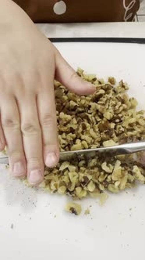 Children Preparing Walnuts on a Cutting Board