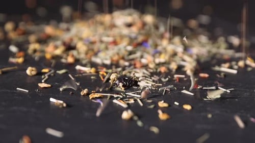 Herbal Tea Leaves Poured onto Dark Background Close Up