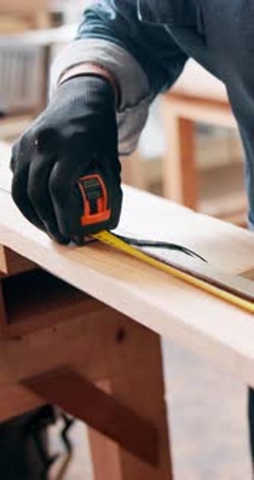 Carpenter, wood and hands with tape measure, project and woodwork or construction