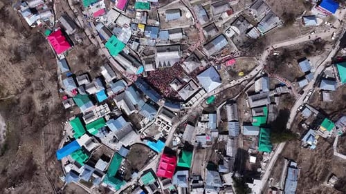 Aerial View of Village with Large Crowd