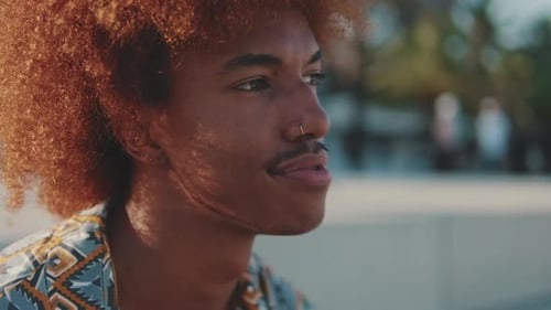 Close-up portrait of young happy man in the city, African American boy smiling