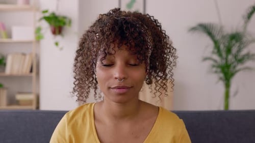 Smiling Woman with Curly Hair Looking at Camera