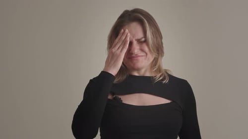 Distressed Woman Holding Head, Crying