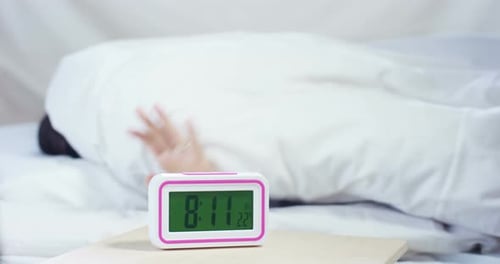 Hand Turns Off Alarm Clock in the Morning