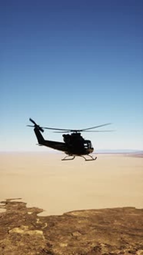 Retro American Military Helicopter Flying Over Desert Landscape