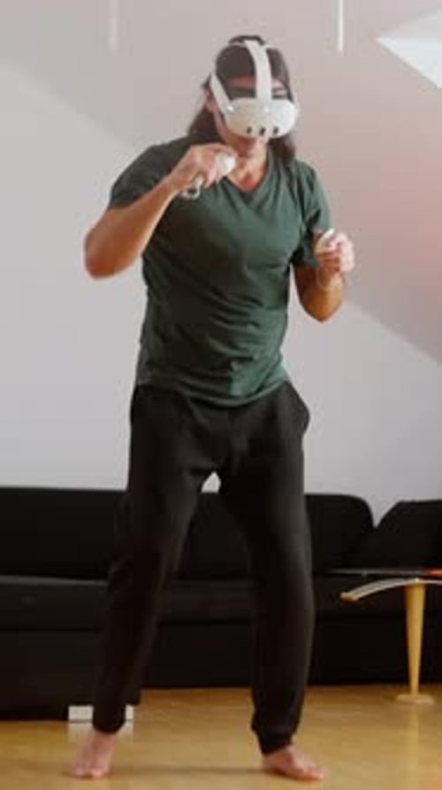 Man Wearing VR Headset Boxing at Home
