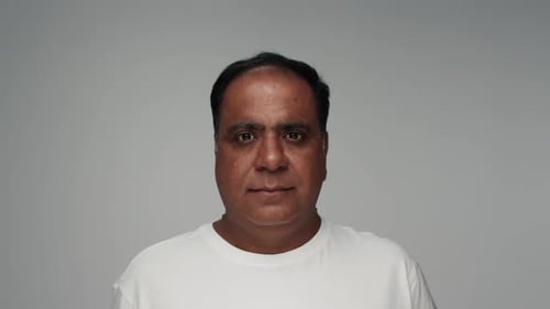 Man Opens Eyes and Smiles in Close Up