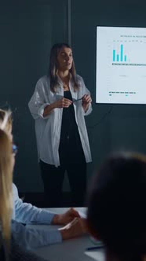 Business Presentation by Woman to Colleagues in Office