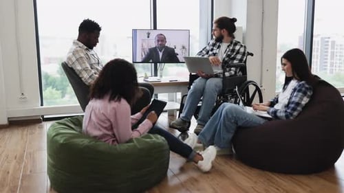 Diverse Team Having Video Conference with Manager in Modern Office