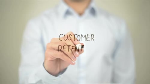 Customer Retention Man Writing on Transparent Screen
