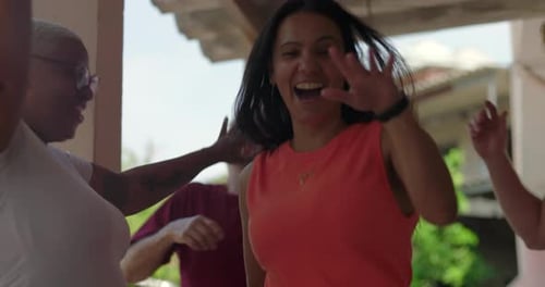 Group of friends dancing and laughing together outdoors, celebrating friendship and connection