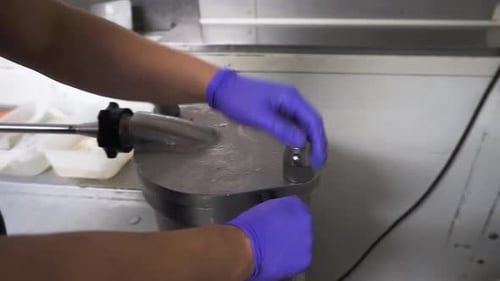 Butcher preparing for sausage stuffing, close up view