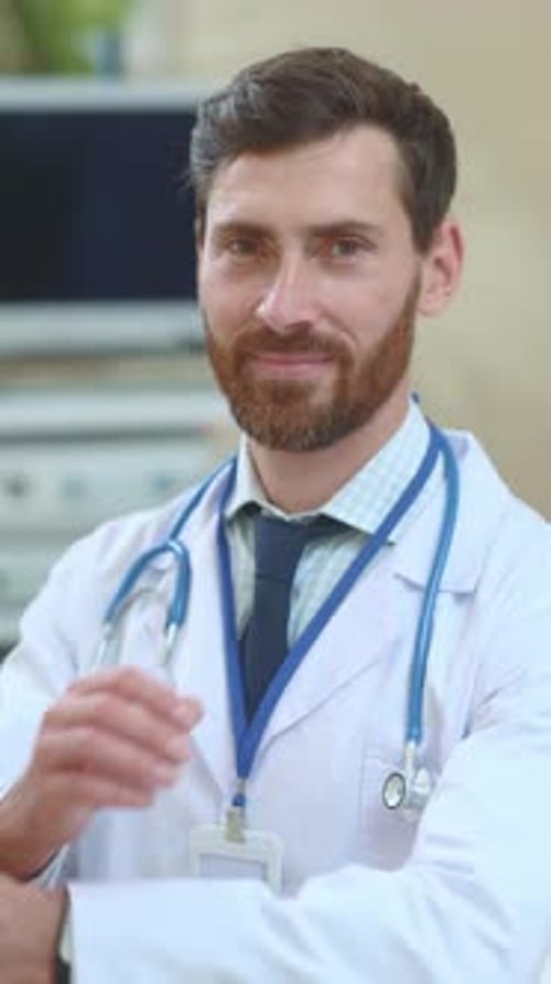 Smiling Doctor in White Coat at Hospital