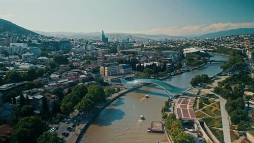 Aerial View of Downtown Tbilisi Georgia Showing the Cityscape River and Modern Glass Pedestrian