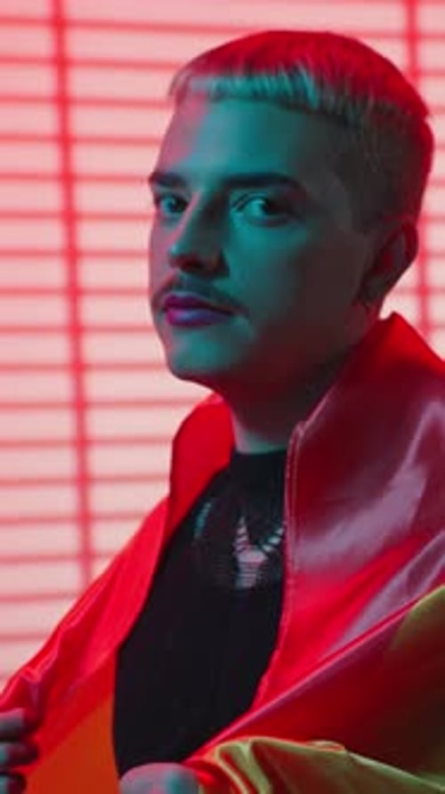 Expressive Young Adult Posing with Pride Flag