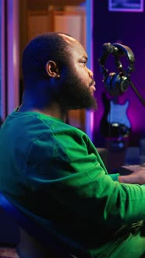 Vertical Video Talented Artist Composing New Lyrics for His Tracks and Recording Music