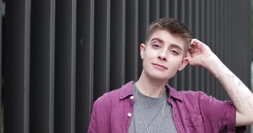 Stylish Young Adult Leaning Against Urban Wall