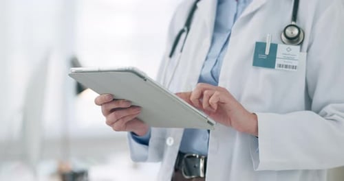Doctor Using Tablet in Medical Setting