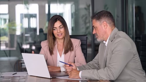 Happy Business Man and Woman Executives at Office Meeting with Laptop
