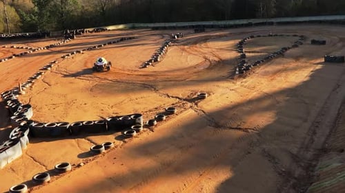 Lightweight Buggy Car Racing On A Dirt Track In Summer. - aerial shot