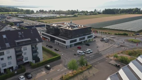 Dynamic aerial of photovoltaic solar panels on top of an office building on a sunny summer day