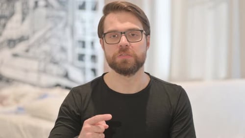Man Speaking to Camera and Gesturing with Fingers